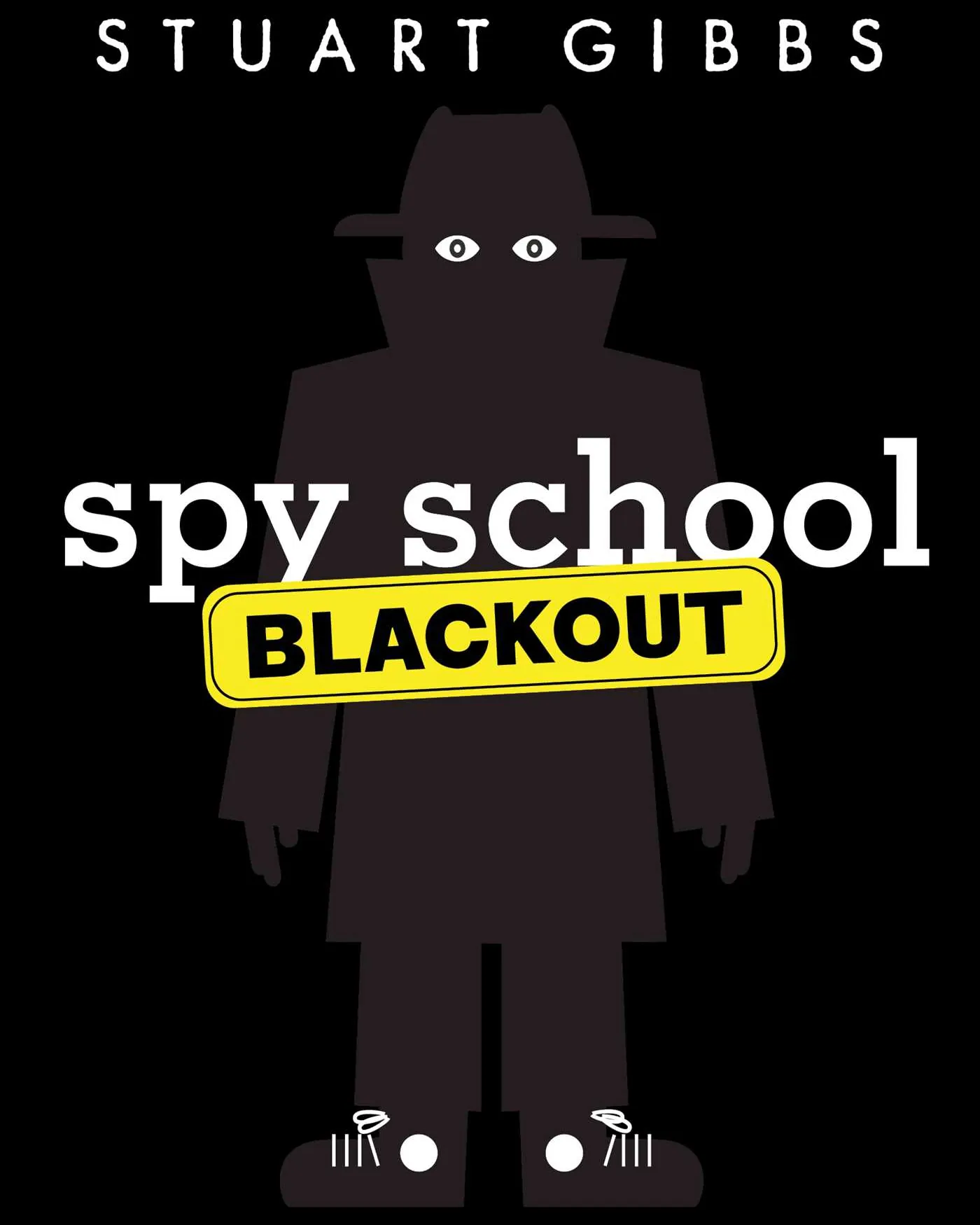 Author holding a completed Spy Academy activity book in a modern workspace.